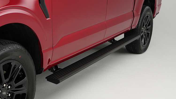 Automated running board on red SUV